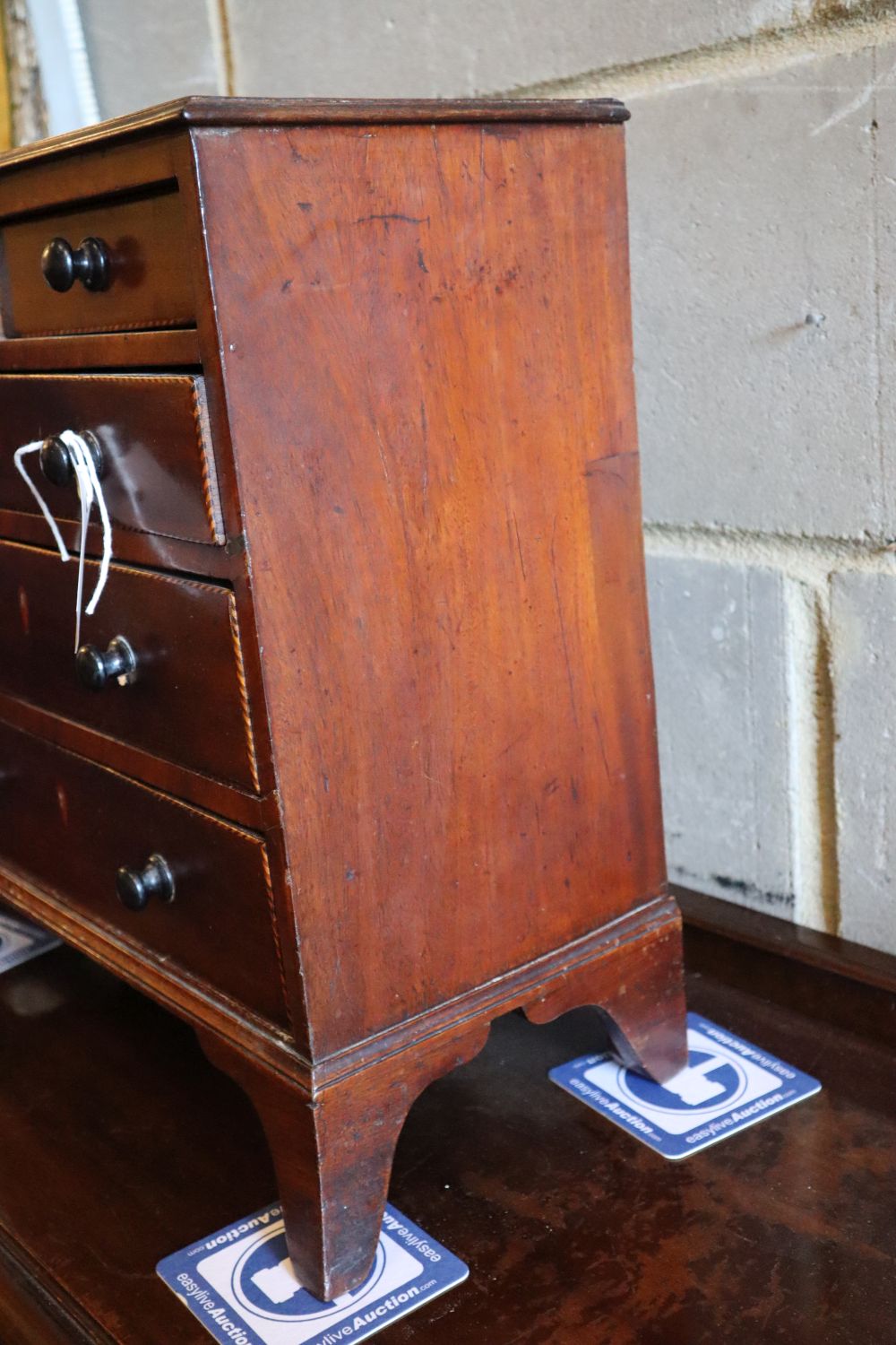 A George IV inlaid mahogany apprentice chest of drawers, width 42cm, depth 20cm, height 44cm